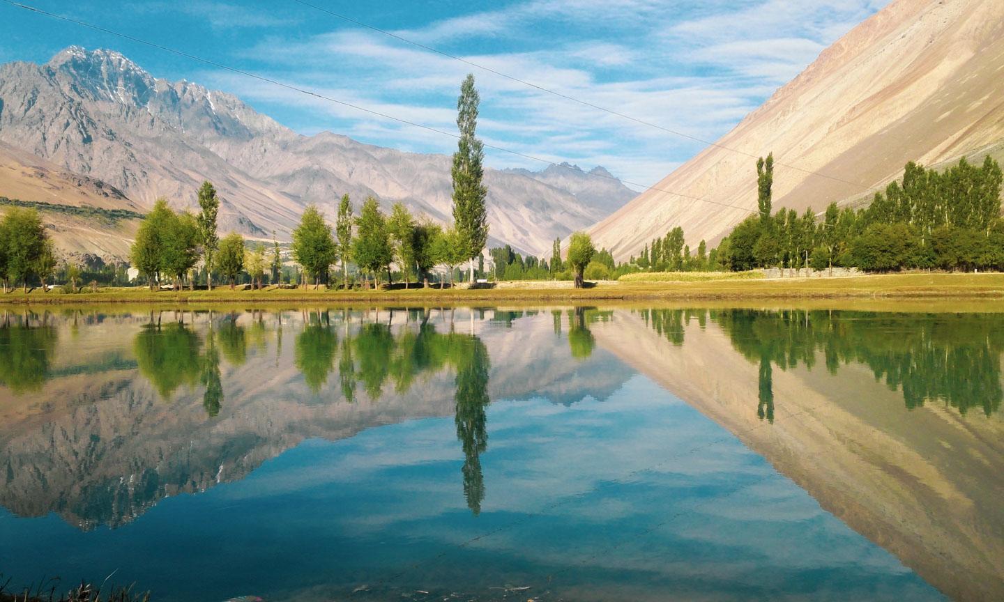 The enormity of mountains reflected in Gilgit River