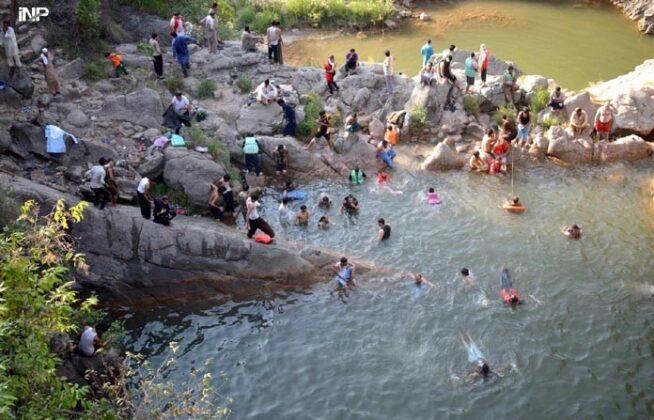 People enjoying swimming in summers in Neela Sandh Lake