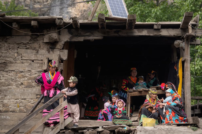 Daily life in Kalash Valley with villagers walking through traditional village paths