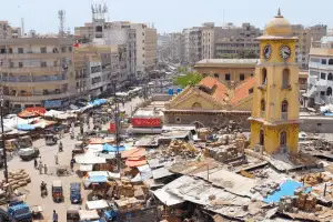 Early morning street scene in Larkana Sindh with bicycles, tea stalls, and old-market architecture